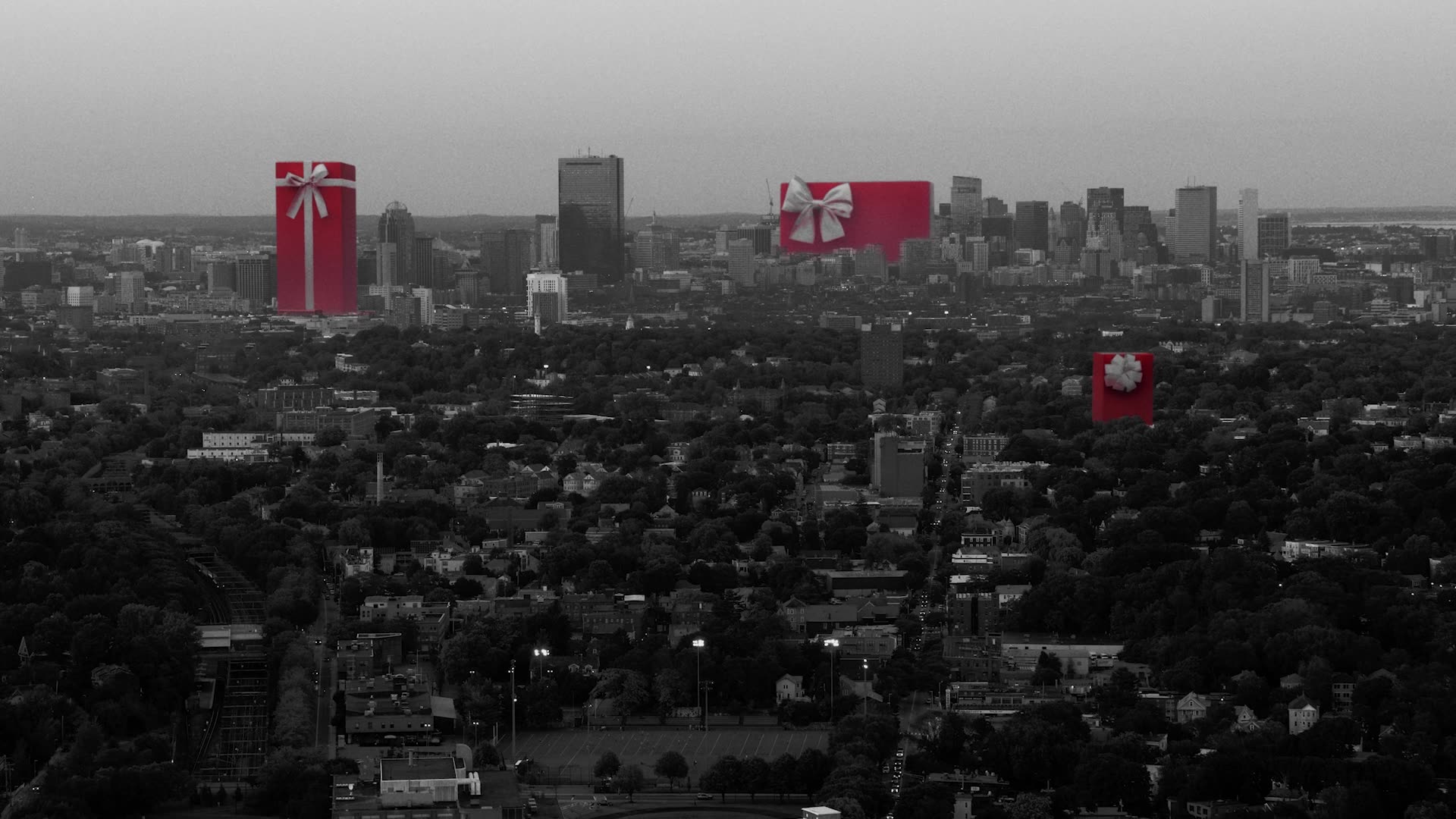 Black and white city skyline with giant red gift boxes